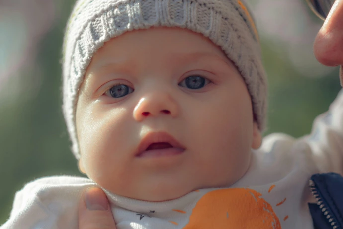 a baby with a white hat